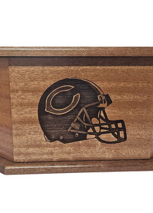 A wooden box with a carved image of a football helmet on it.