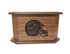 A wooden box with a carved image of a football helmet on it.
