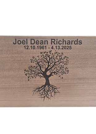 The image is a wooden plaque with a tree design and the text "Joel Dean Richards 12.10.1961 4.13.2025" printed on it.