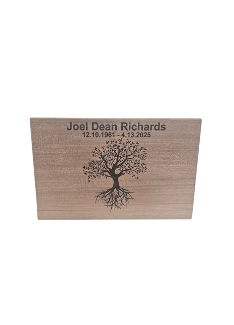 The image is a wooden plaque with a tree design and the text "Joel Dean Richards 12.10.1961 4.13.2025" printed on it.
