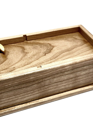 a small wooden box with a single piece of wood in it