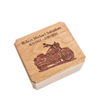 A wooden box with a carved image of a motorcycle on it, and the text 