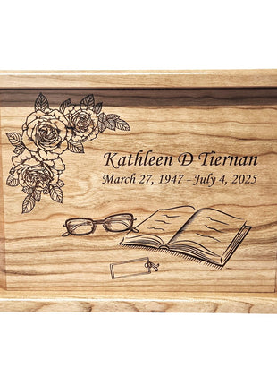 A wooden urn with a floral design and a pair of glasses on it.