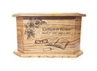 A wooden urn with a floral design and a pair of glasses on it.