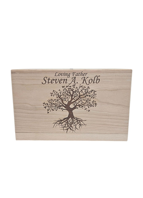 A wooden box with a tree design and the text " Loving Father Steven A. Kolb" engraved on it.