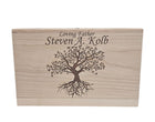 A wooden box with a tree design and the text 