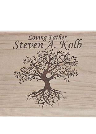A wooden box with a tree design and the text " Loving Father Steven A. Kolb" engraved on it.