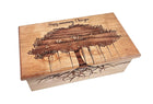 A wooden box with a tree design and the text 