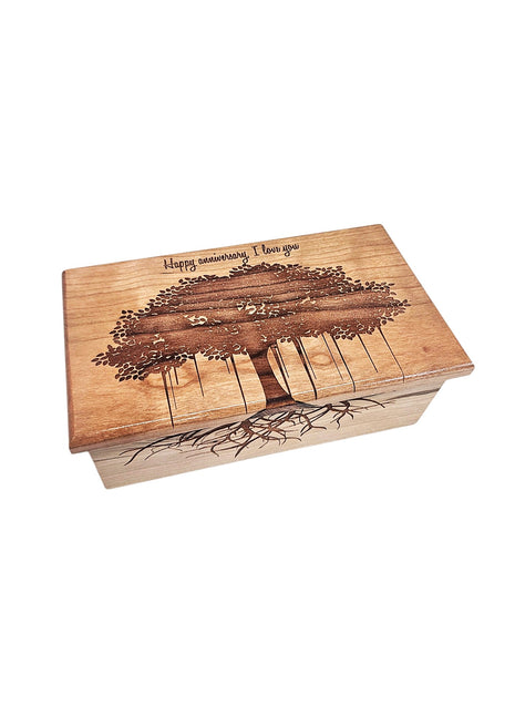 A wooden box with a tree design and the text "Happy anniversary I love you" engraved on it.