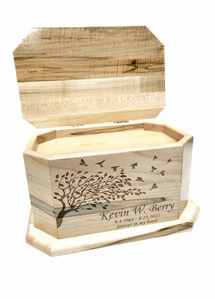 a wooden box with a tree on it