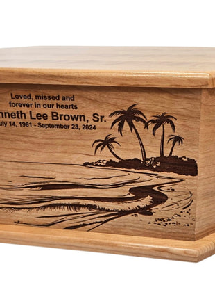 A wooden urn with a memorial plaque engraved on it. The plaque features a beach scene with palm trees and a wave.