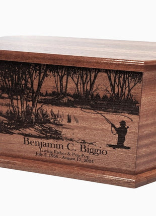 A wooden urn with a carved image of a person fishing in a river, surrounded by trees.