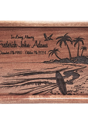 A wooden urn with a carved design depicting a beach scene with palm trees and a surfer.