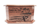A wooden urn with a carved design depicting a beach scene with palm trees and a surfer.