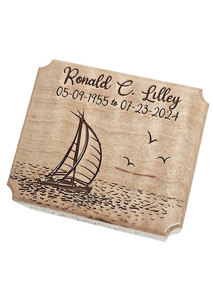 The image is a wooden plaque with a sailboat and waves engraved on it.