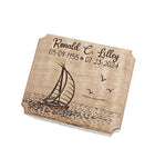 The image is a wooden plaque with a sailboat and waves engraved on it.