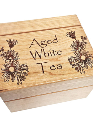 A wooden box with the text "Aged White Tea" engraved on it.
