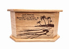 The image is a wooden urn or urn-like container with a carved design depicting a beach scene with palm trees. The text on the urn reads 