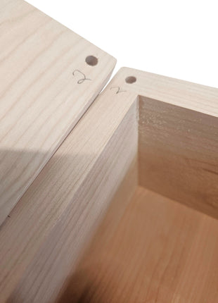 two wooden planks with holes in them, placed next to each other.