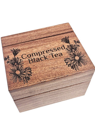 A wooden box with the text "Compressed Black Tea" engraved on it.